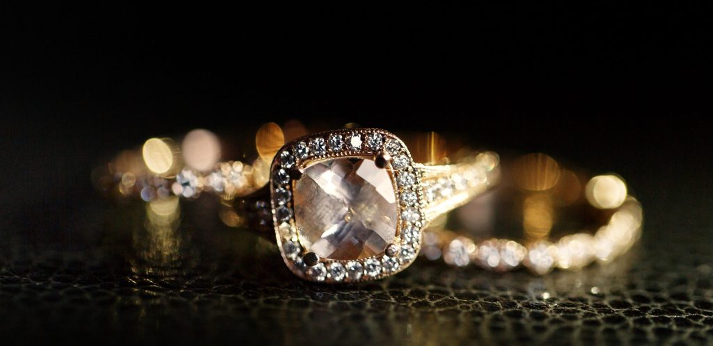 jewels sparkle in the golden wedding rings lying on the leather